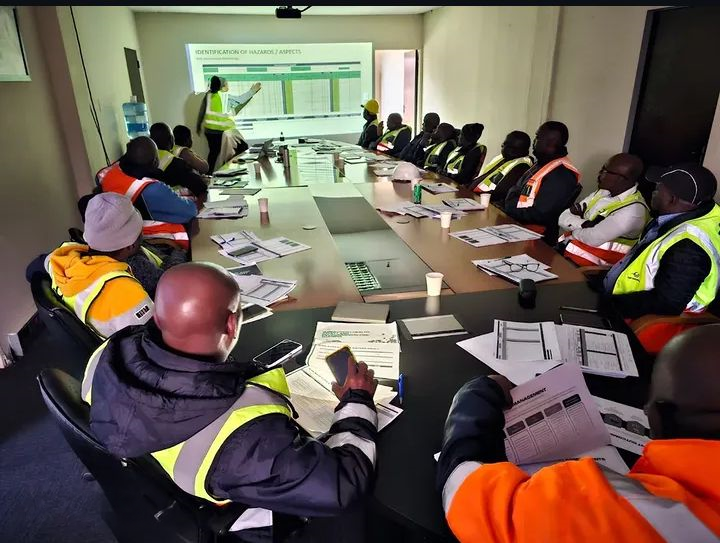 SHEQ workshop in progress with site personnel reviewing a hazard and aspects register